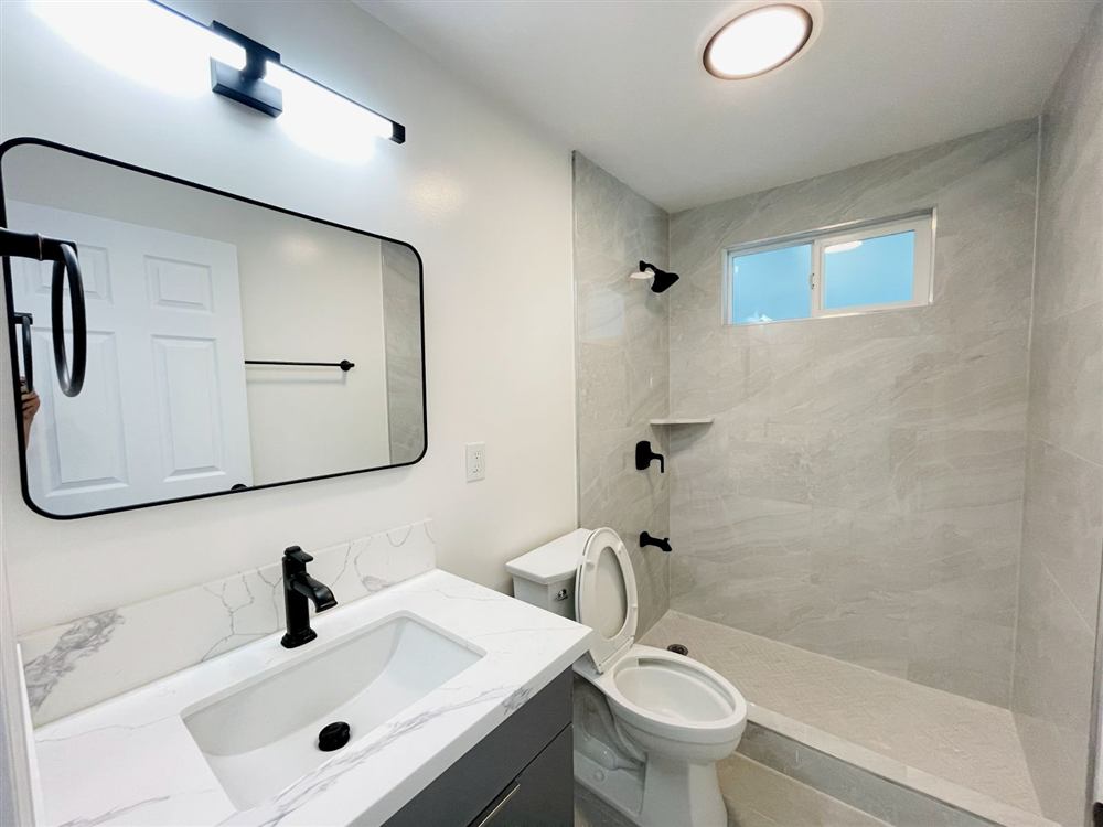 Remodeled bathroom with tiled shower